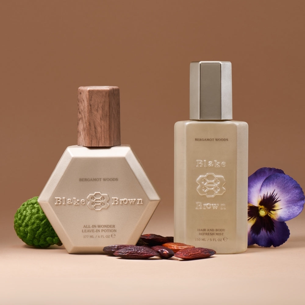Blake Brown Bergamot Woods Leave-In Potion and Refresh Mist styled with bergamot, tonka beans, and a violet on a warm brown background.