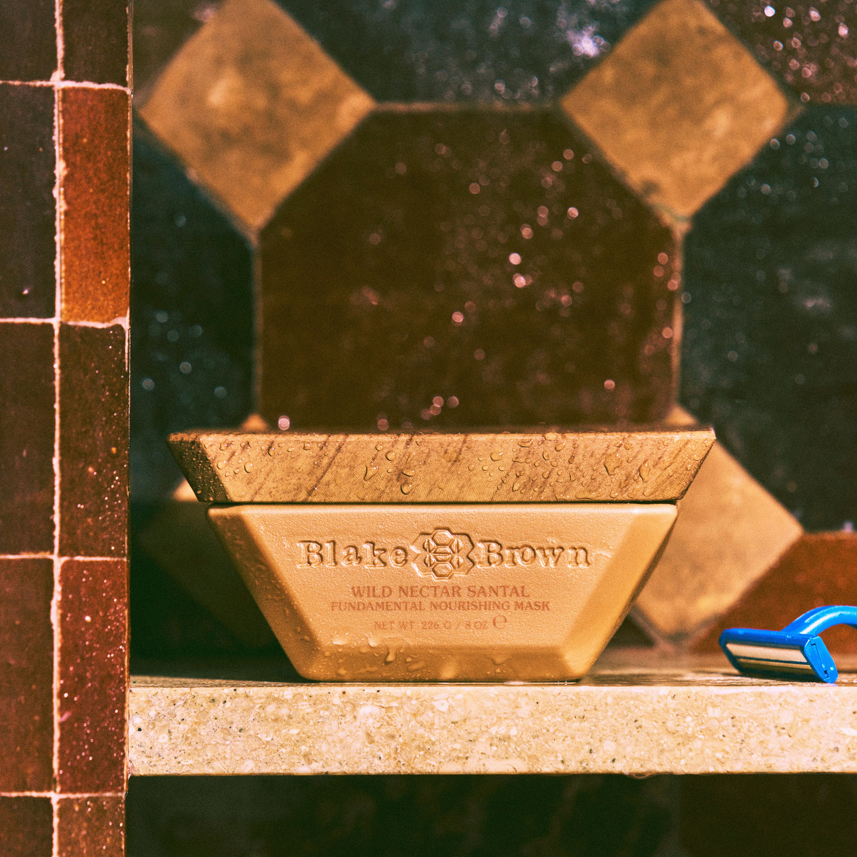 Blake Brown Wild Nectar Santal Fundamental Nourishing Hair Mask by Blake Lively placed on a shower shelf, highlighting its moisture-rich formula.