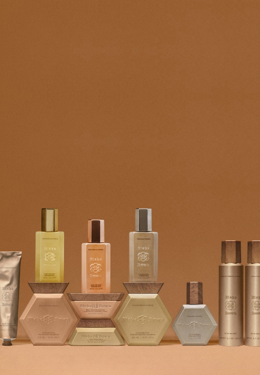 Full Blake Brown hair product collection displayed on a warm brown background, complete with the new Hair & Body Refresh Mists.