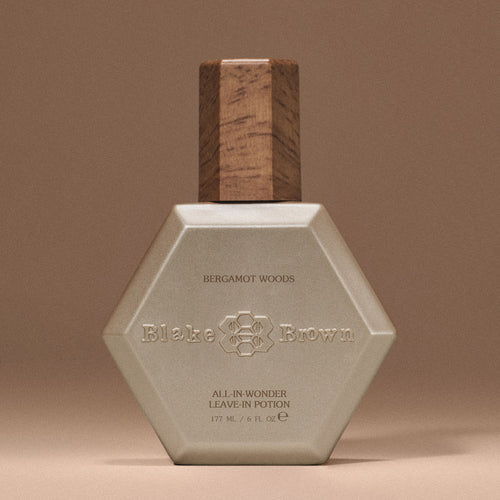 Woman's hands preparing to apply Blake Brown Nourishing Mask by Blake Lively, showcasing its creamy texture and hydrating effects on hair.