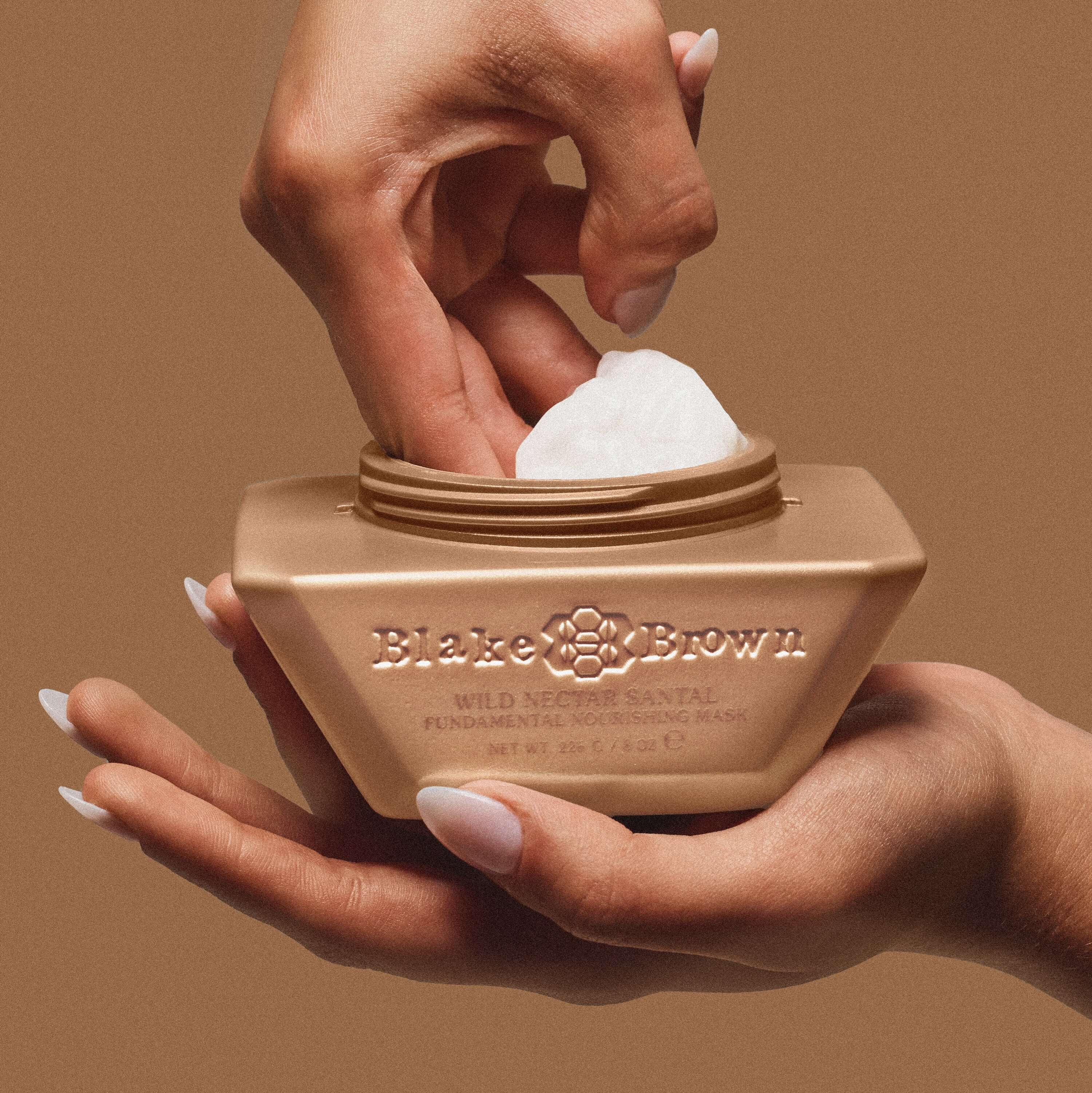 Blake Brown by Blake Lively nourishing shampoo and hair masks surrounded by foam, emphasizing its clean, cruelty-free, and vegan ingredients.