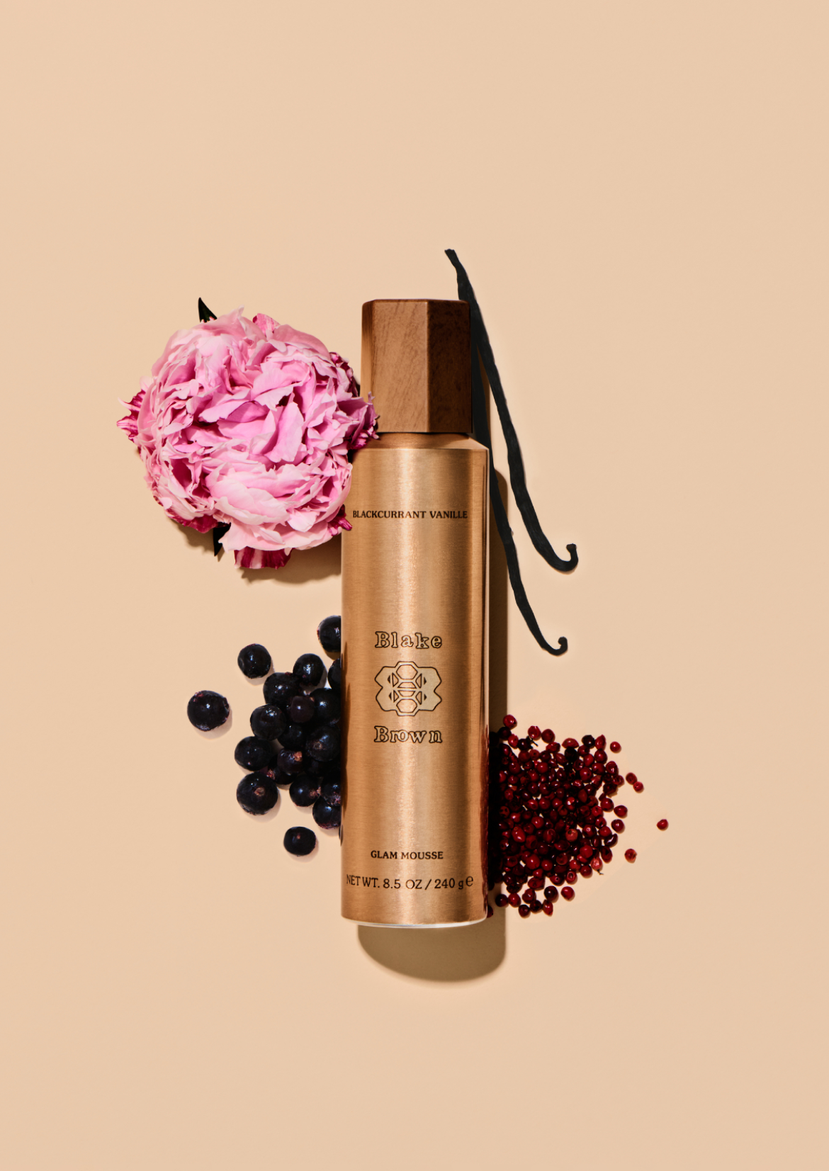 Blake Brown Glam Mousse styled with blackcurrant, pink peppercorn, vanilla, and a pink peony to highlight its Blackcurrant Vanille fragrance.