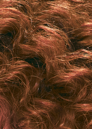 Shiny, reddish-brown, long, wavy hair.