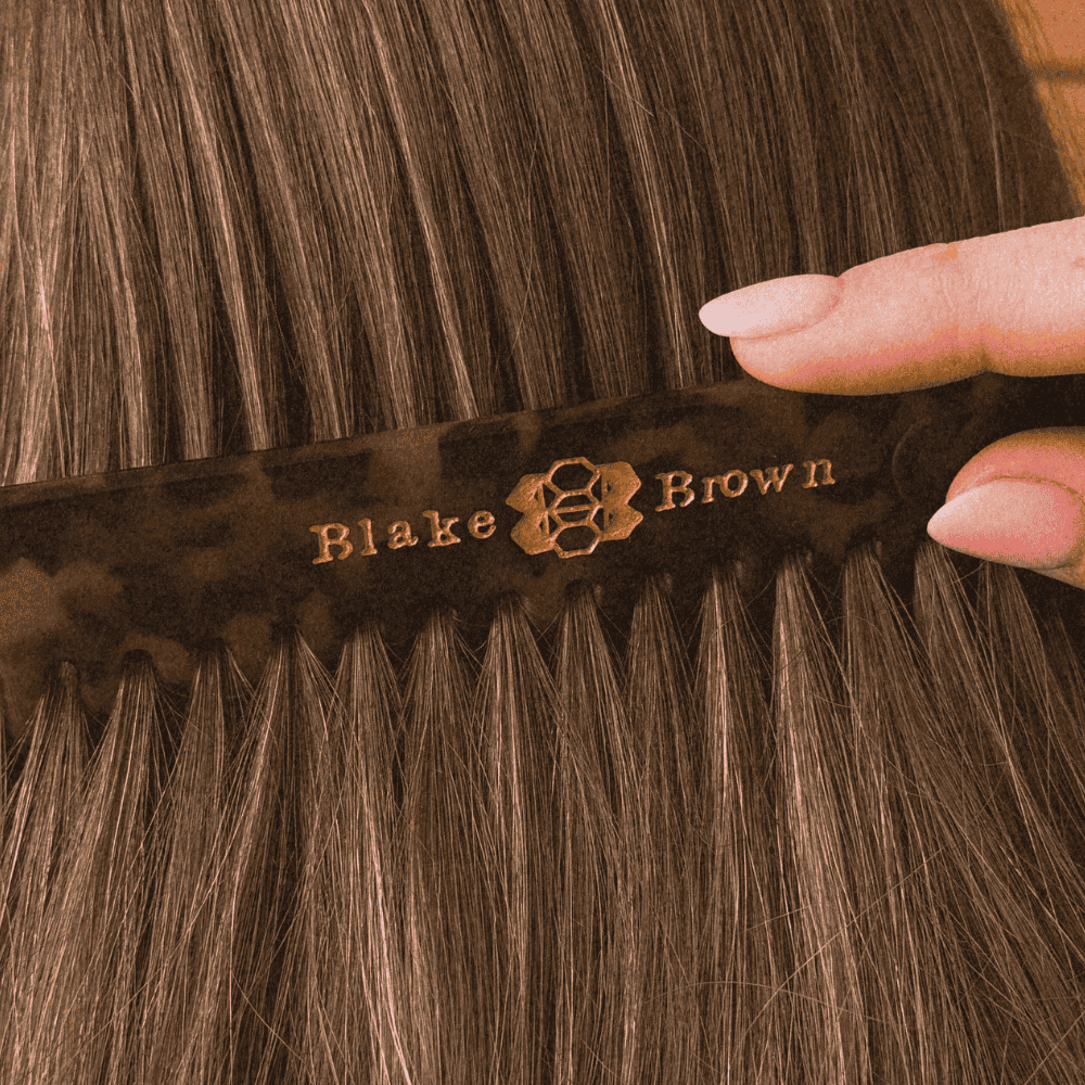 Blake Brown wide-tooth comb in tortoiseshell finish being combed through healthy-looking hair.