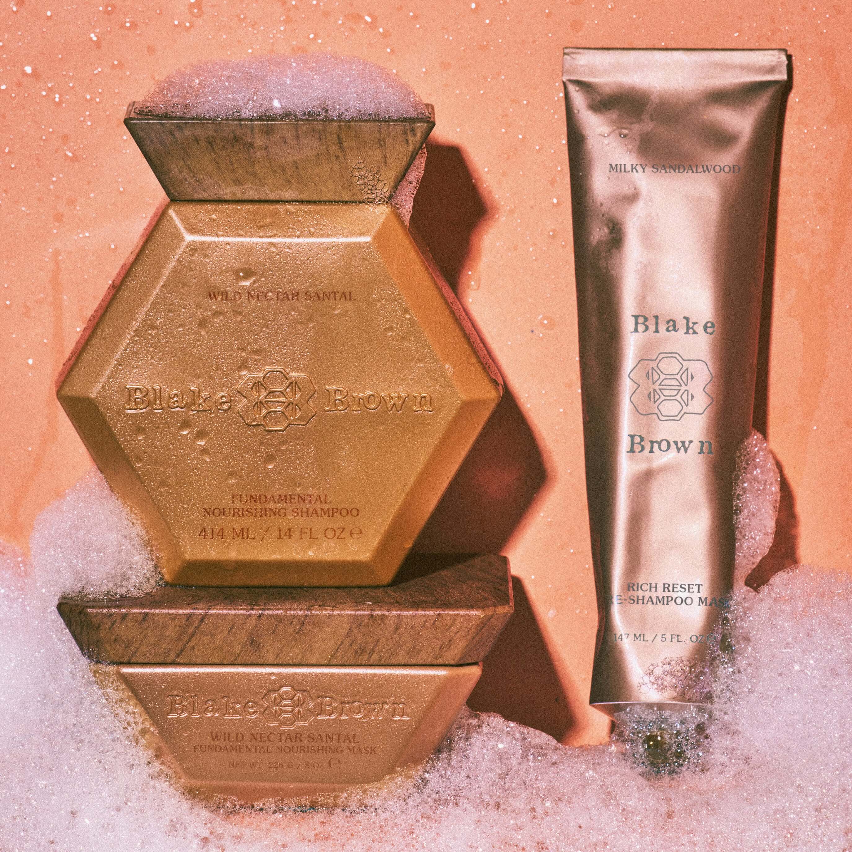 Blake Brown by Blake Lively nourishing shampoo and hair masks surrounded by foam, emphasizing its clean, cruelty-free, and vegan ingredients.