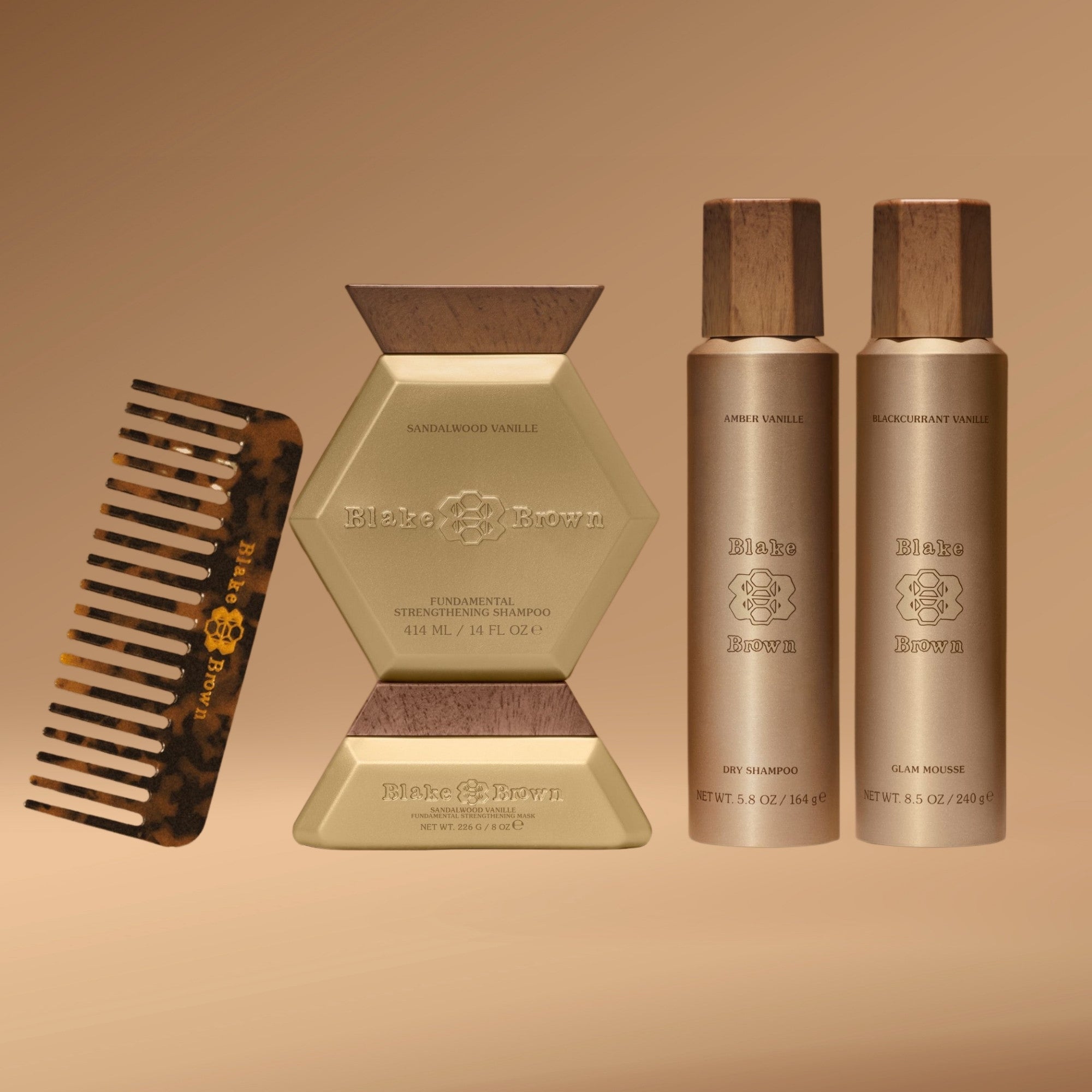 
Blake Brown's Straight Hair Essentials: a wide-tooth comb, Strengthening Shampoo & Mask, Dry Shampoo, and Glam Mousse.
