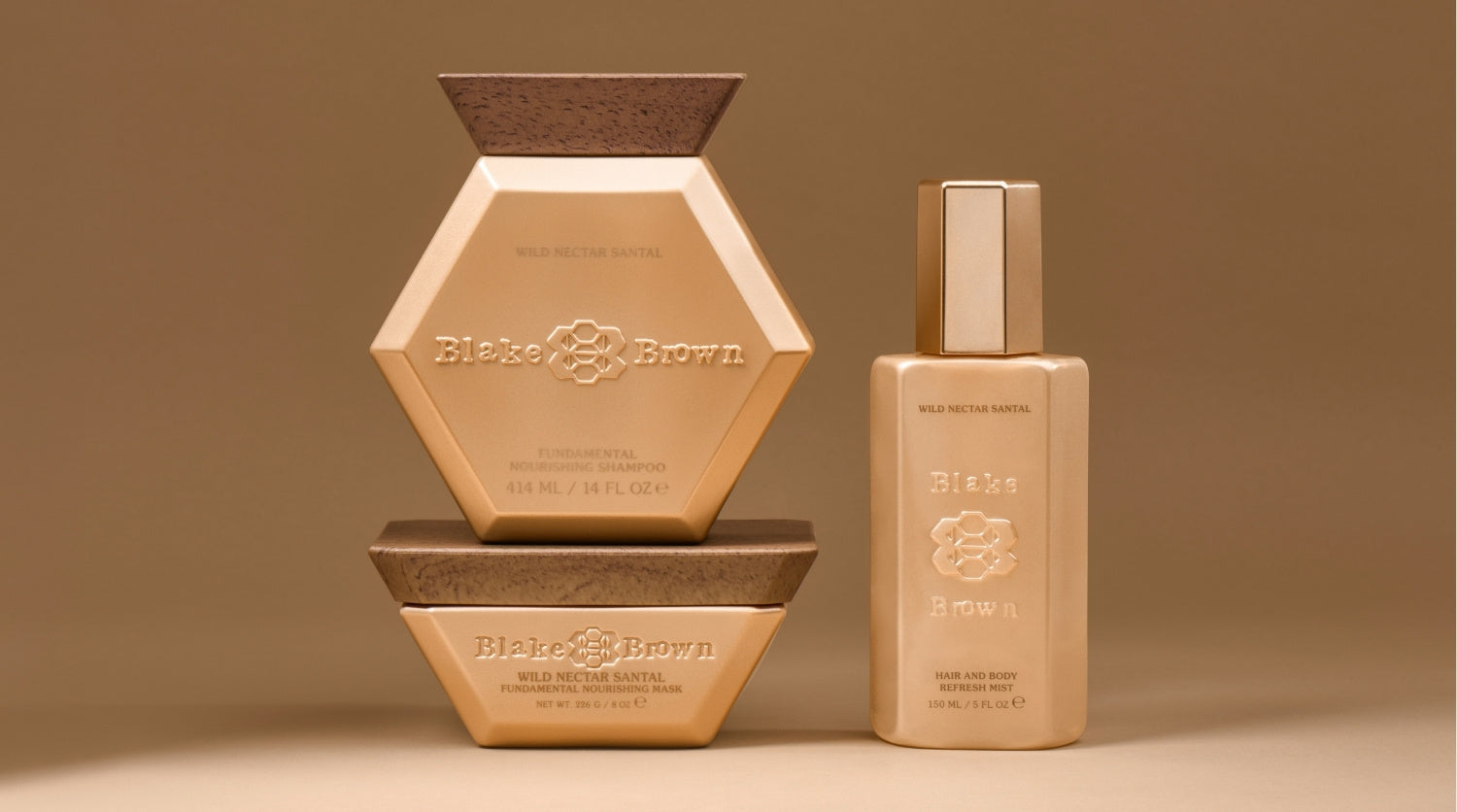 Blake Brown Wild Nectar Santal trio—Fundamental Nourishing Shampoo, Fundamental Nourishing Mask, and Hair and Body Refresh Mist—displayed against a warm beige background.