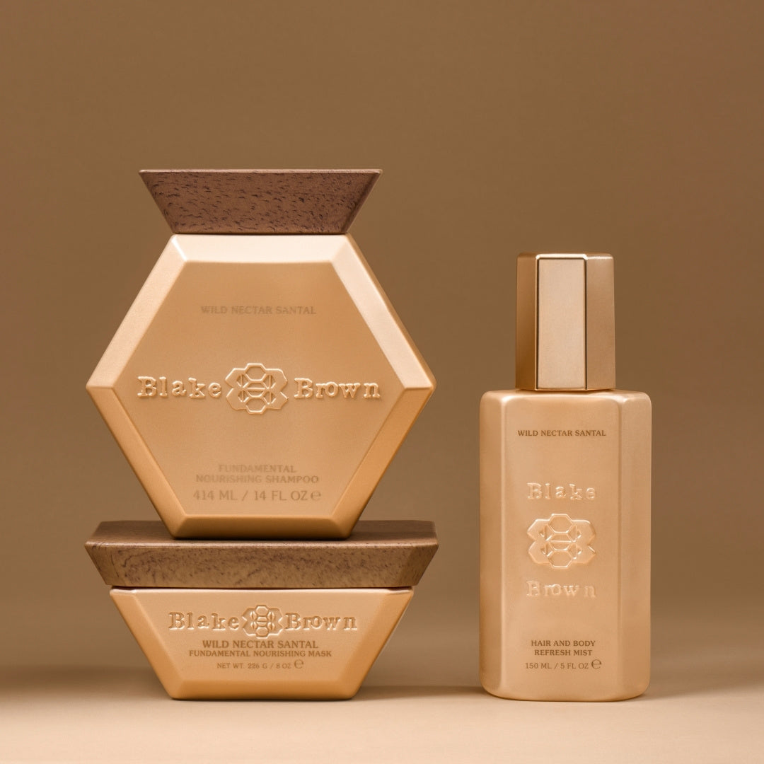 Blake Brown Wild Nectar Santal trio—Fundamental Nourishing Shampoo, Fundamental Nourishing Mask, and Hair and Body Refresh Mist—displayed against a warm beige background.