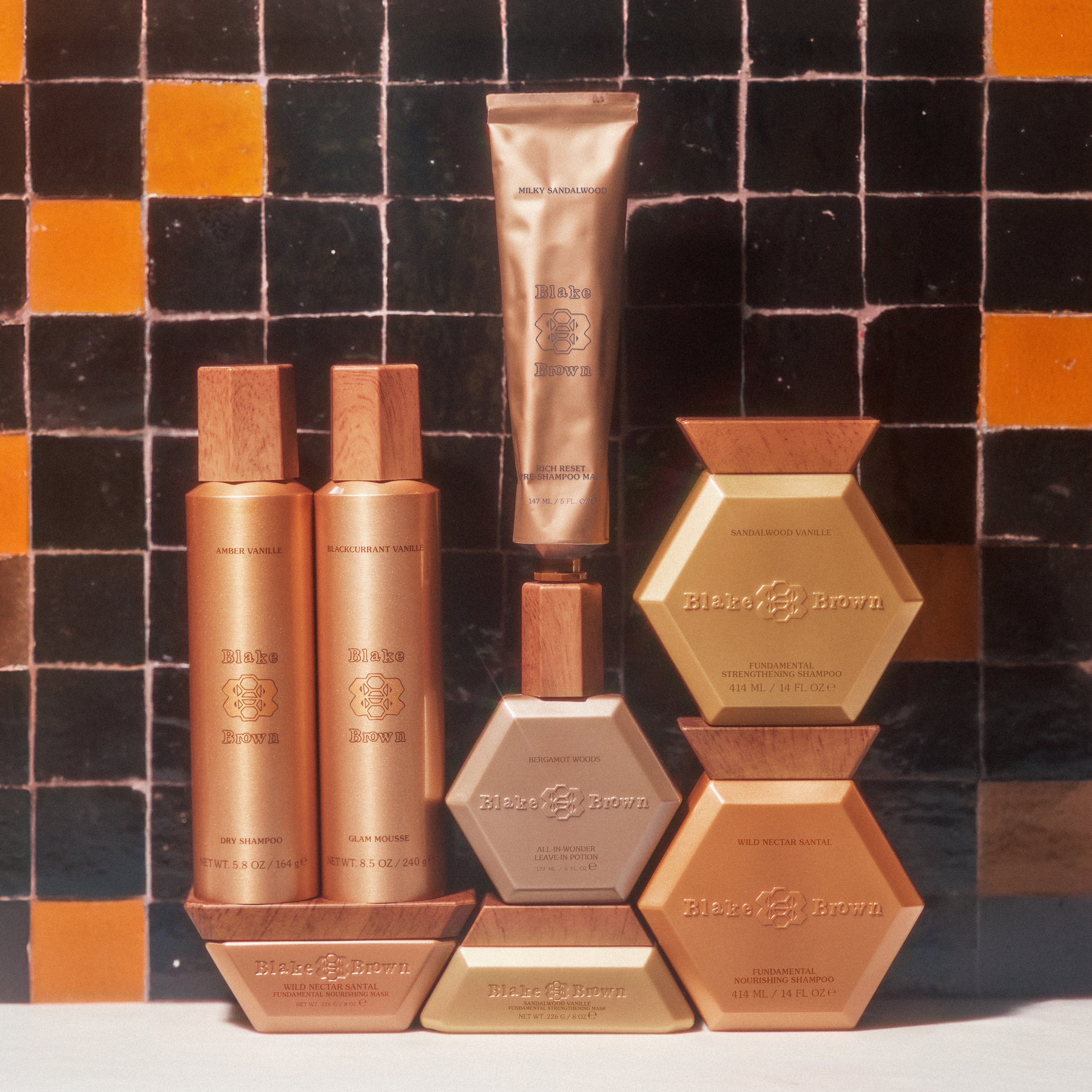 The Complete Blake Brown Hair System by Blake Lively, posing together on a shelf, showing off the haircare line's stylistic design and elegant packaging.