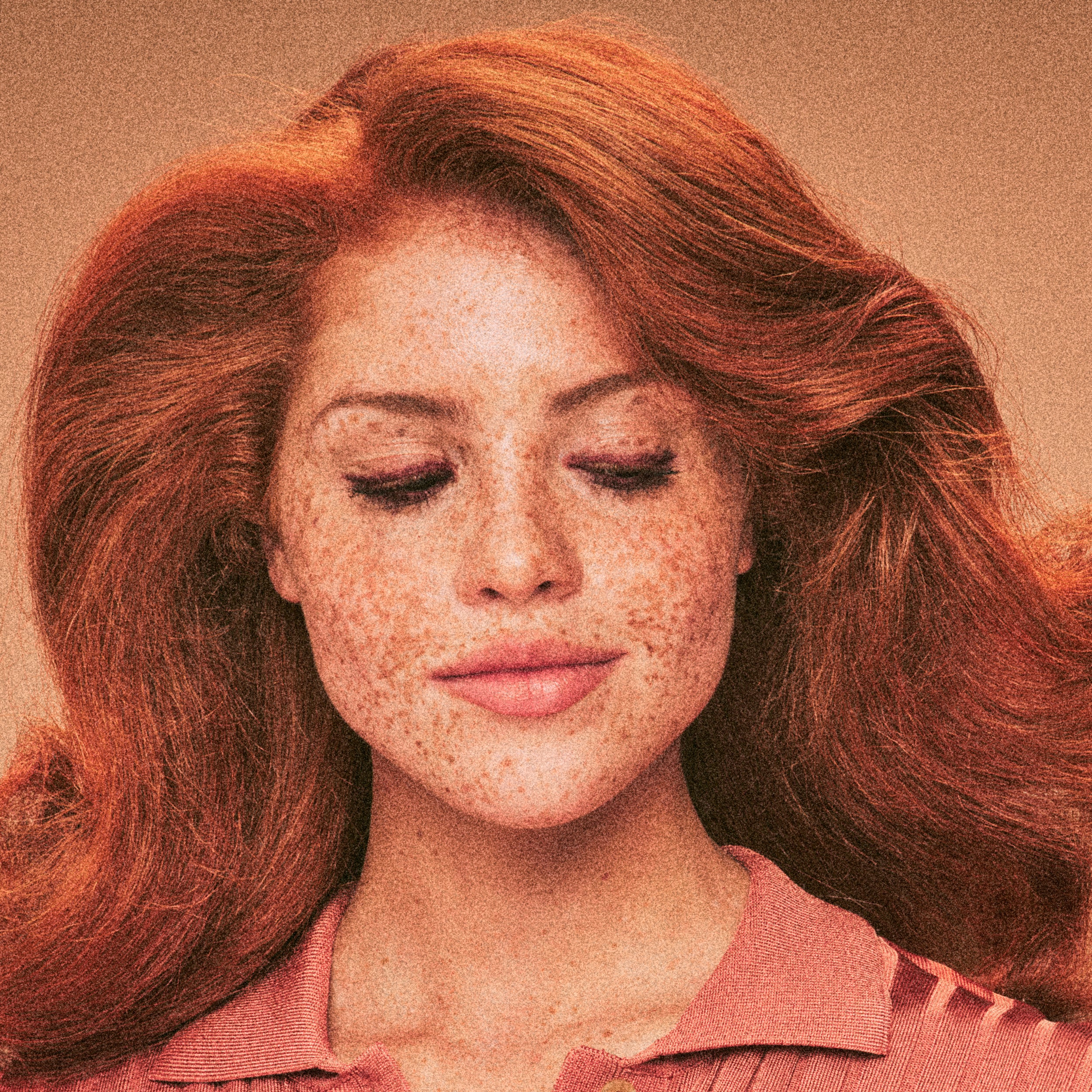 Vintage-style shot of a redhead with bright, shiny hair after using Blake Brown's Every Wash Nourishing Trio, haircare conceived by Blake Lively.